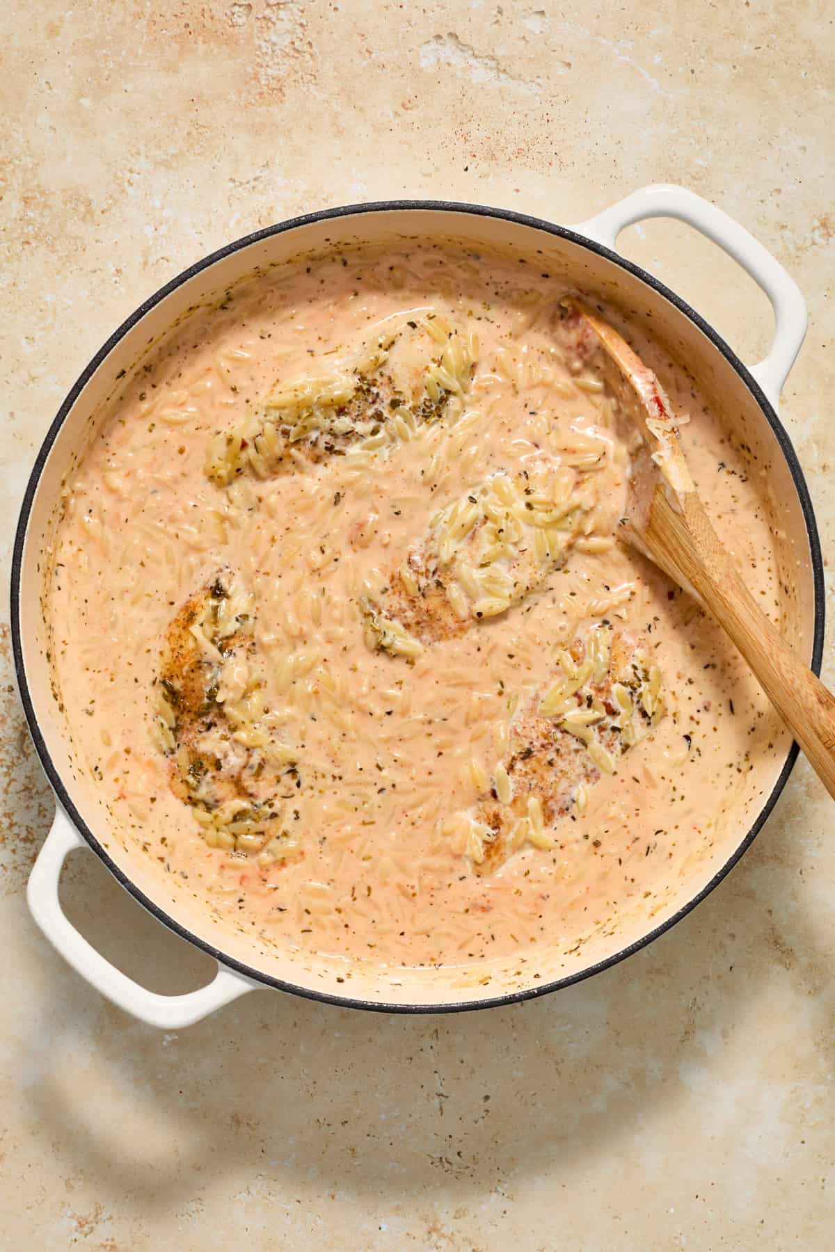 Cream added to pan with cooked orzo and chicken.