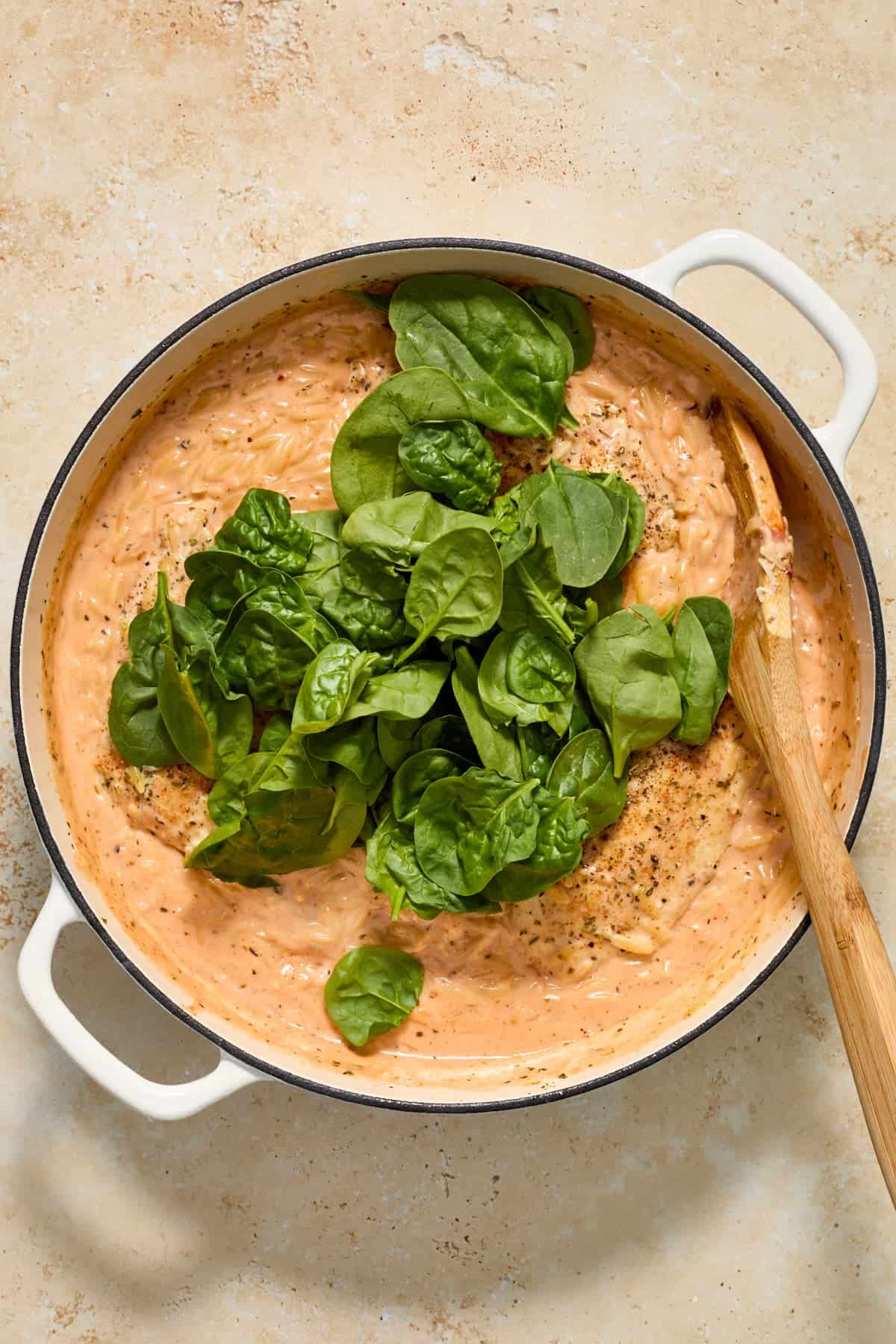 Spinach added to pan with creamy chicken and orzo.