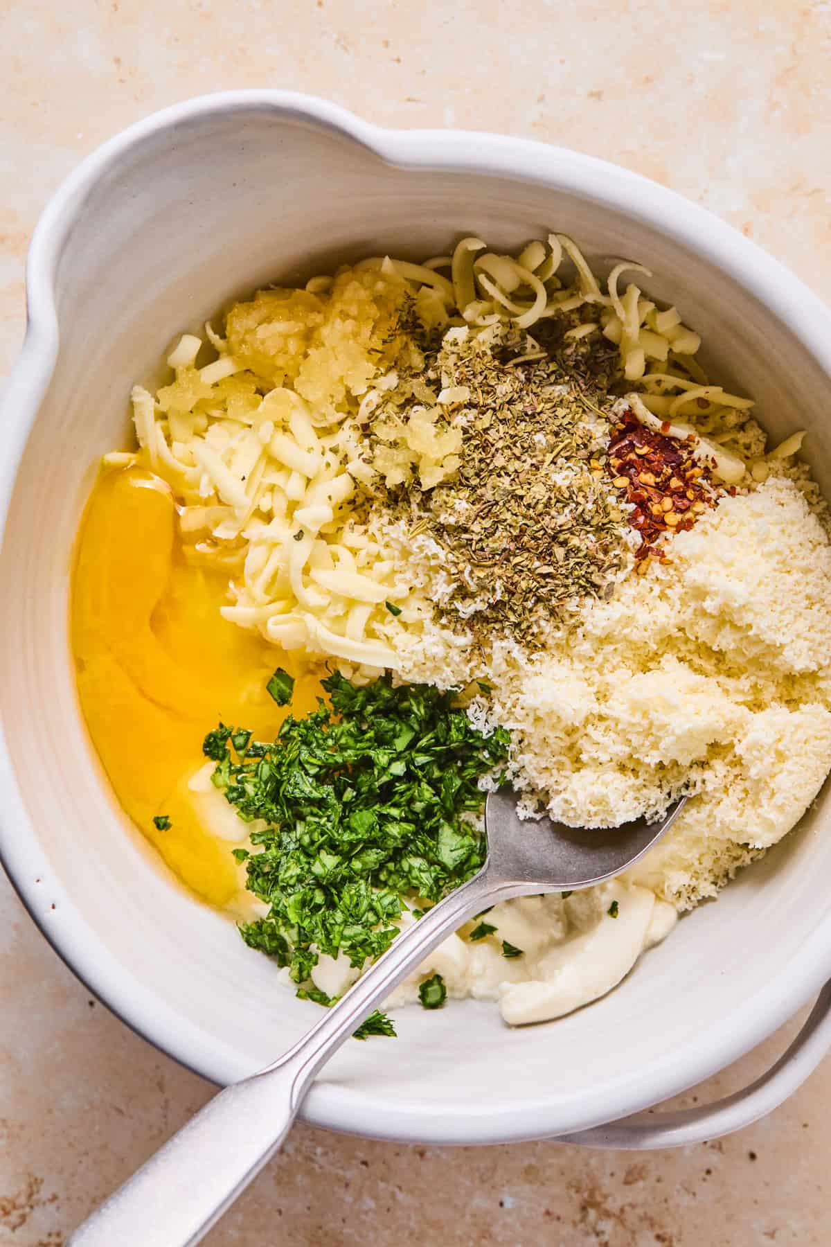 Mixing bowl with egg, ricotta and other ingredients.