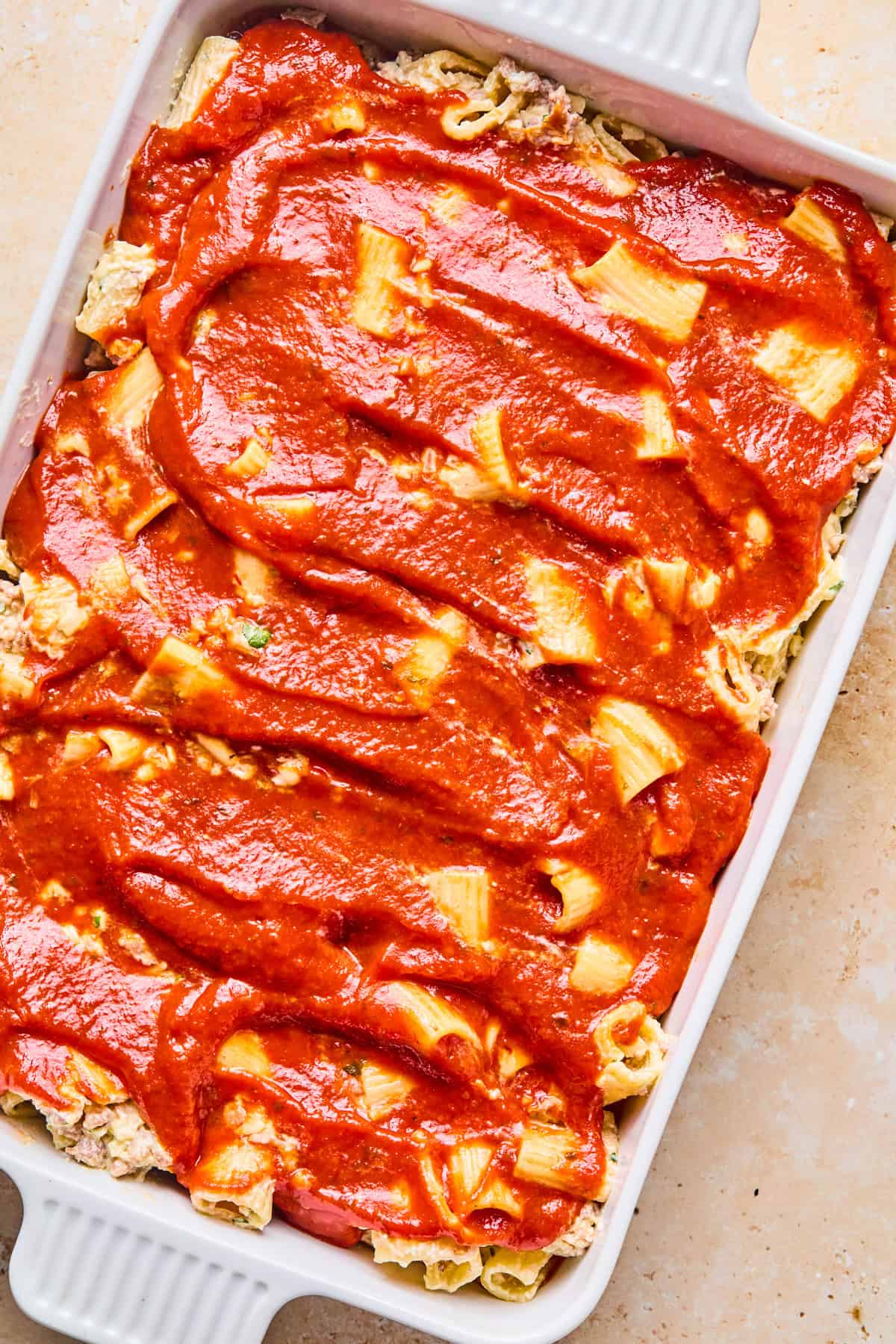 Marinara spread on top of pasta.