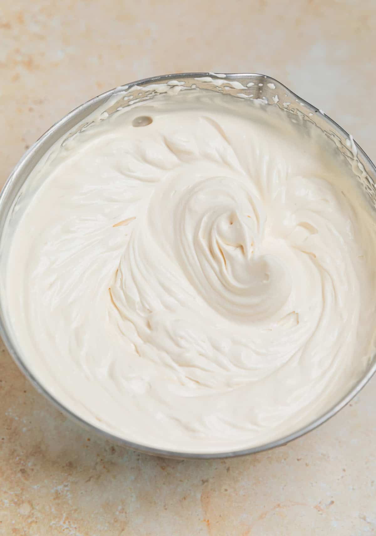 Brown sugar whipped cream beaten to stiff peaks in small bowl.