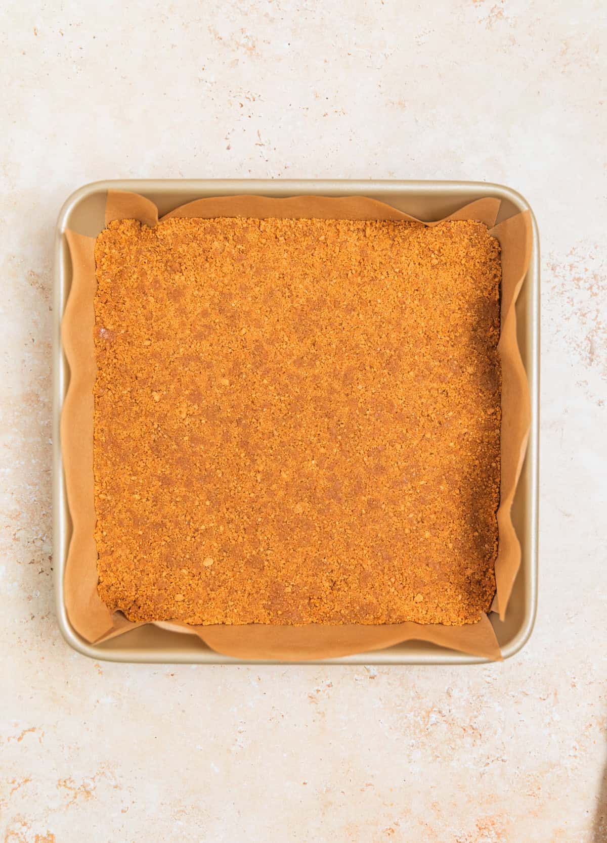 Ginger snap cookie crust pressed into 9 inch square baking pan lined with parchment.