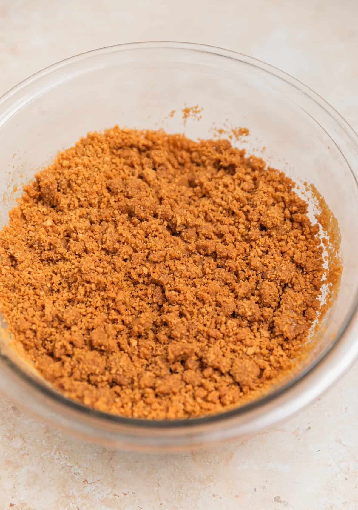 Ginger snap cookie crust mixture in bowl.