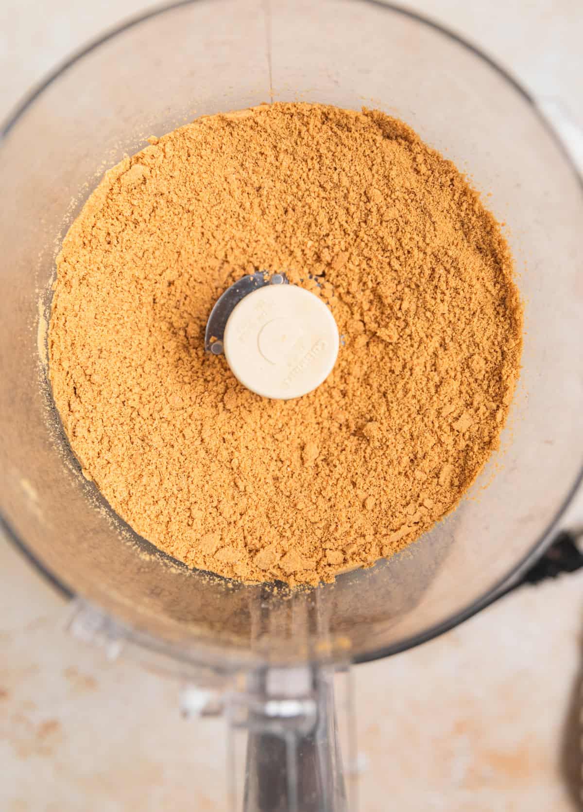 Finely ground ginger snap cookies in food processor.