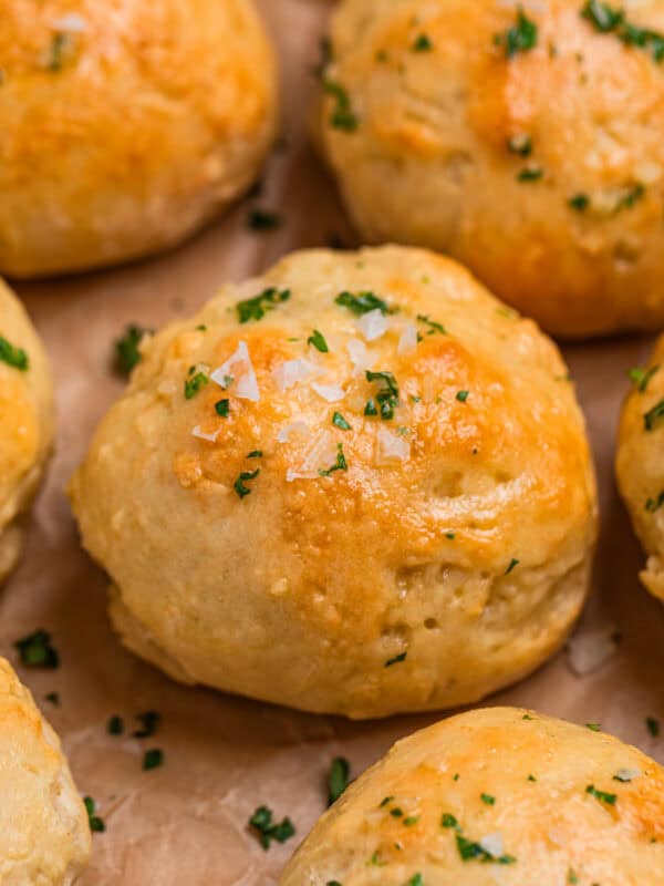 Greek yogurt yeast free dinner rolls topped with garlic butter and parsley.