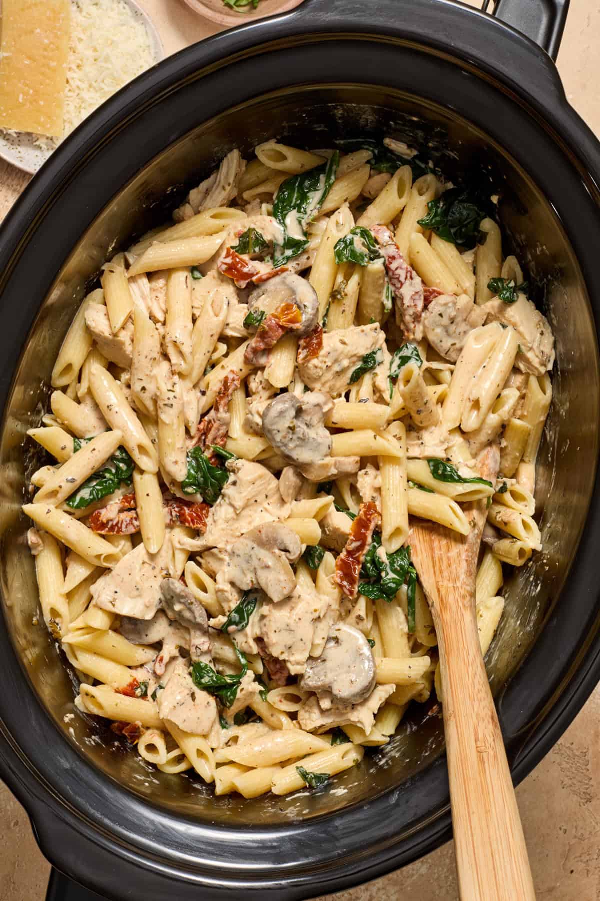 Pasta stirred into creamy chicken mixture in slow cooker.