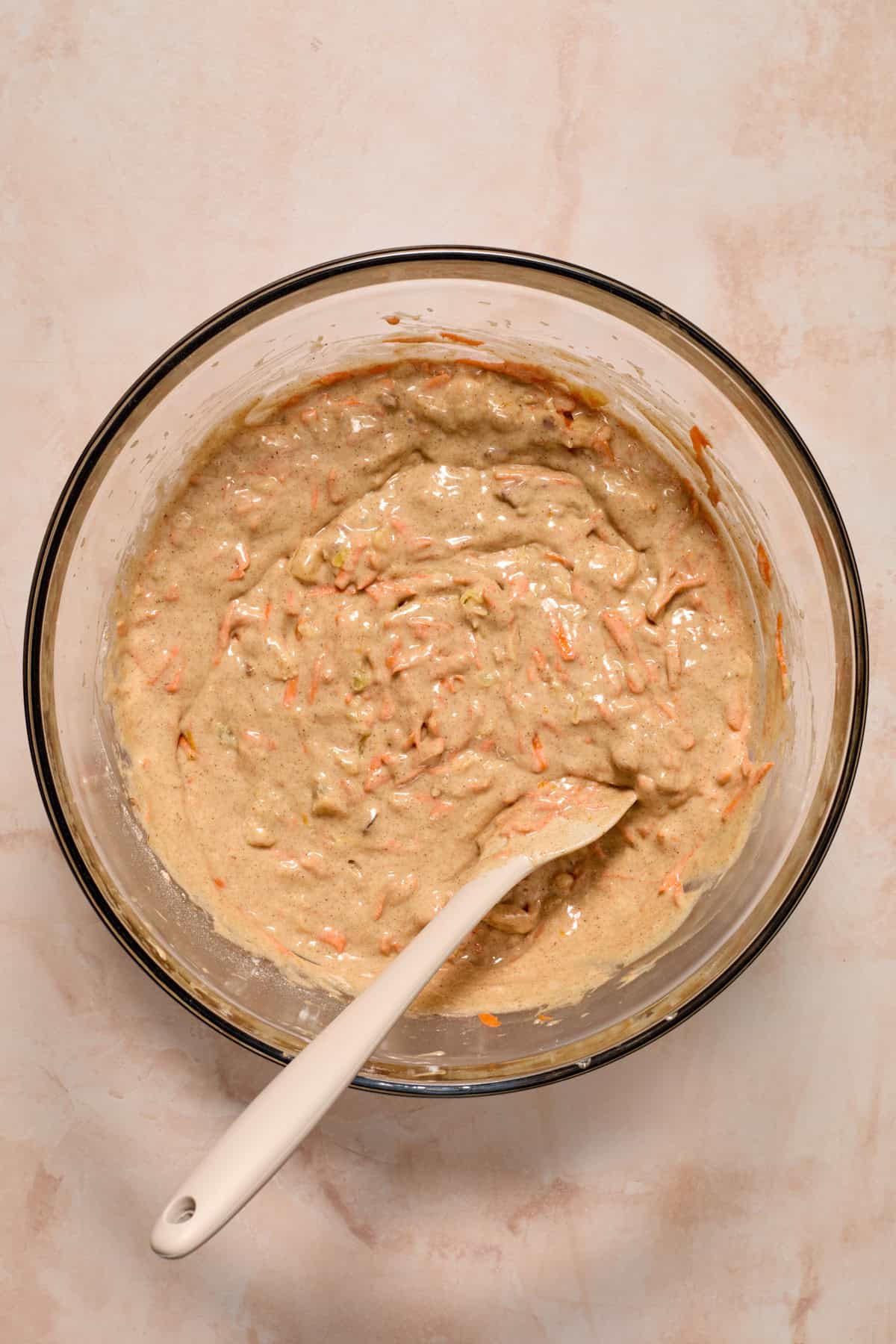 Carrot cake batter mixture made from cake mix in bowl with spoon.