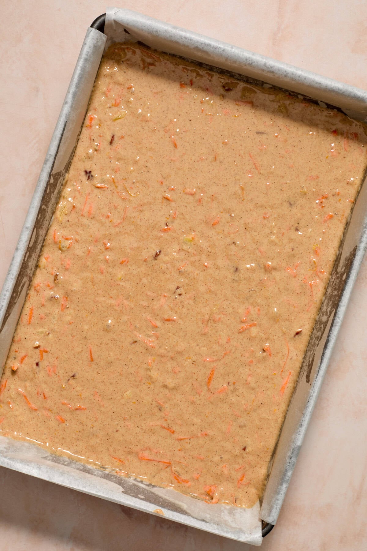 Carrot cake batter in greased glass pan.