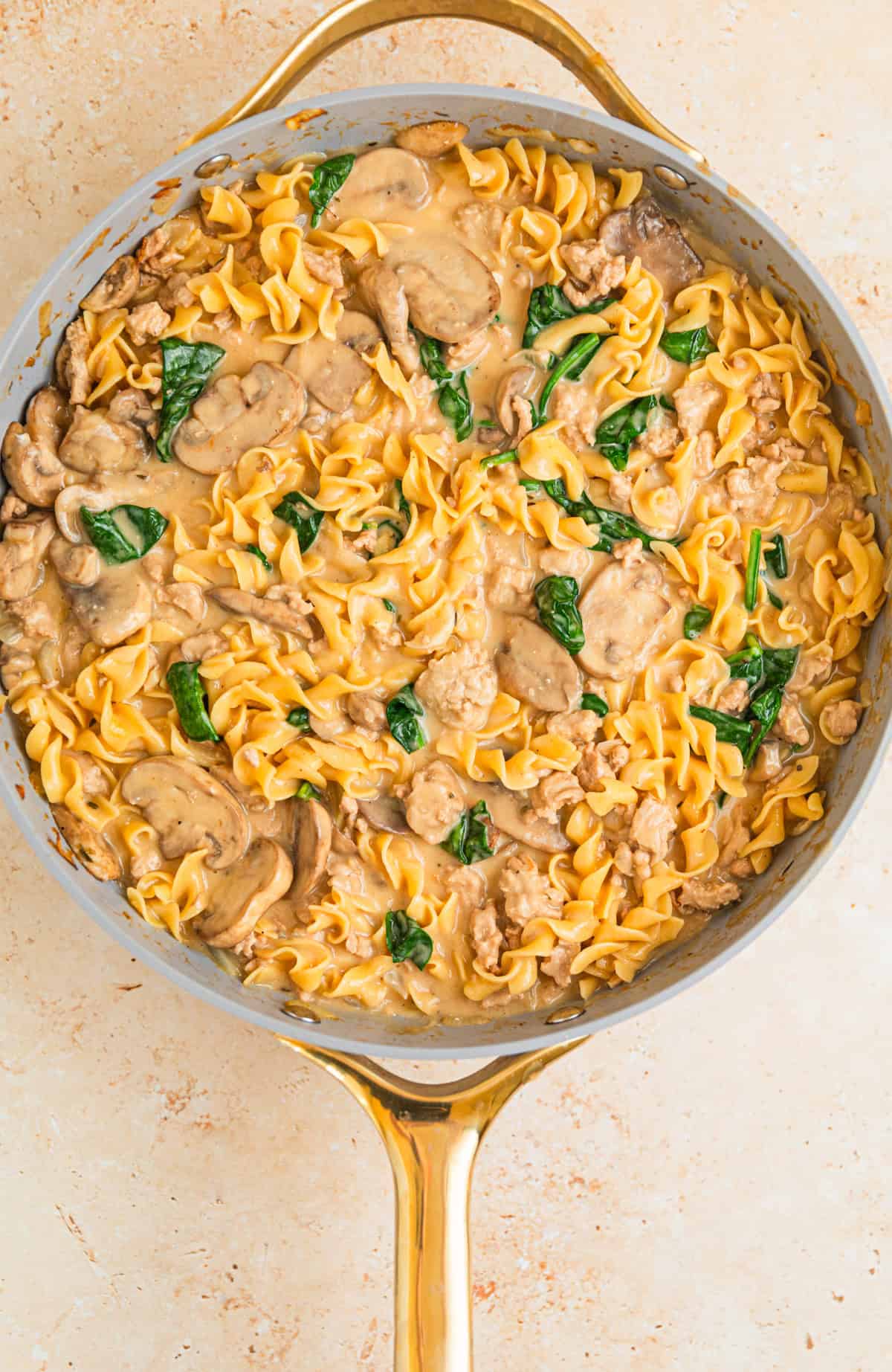 Cream cheese, sour cream and spinach added to skillet with turkey stroganoff ingredients.