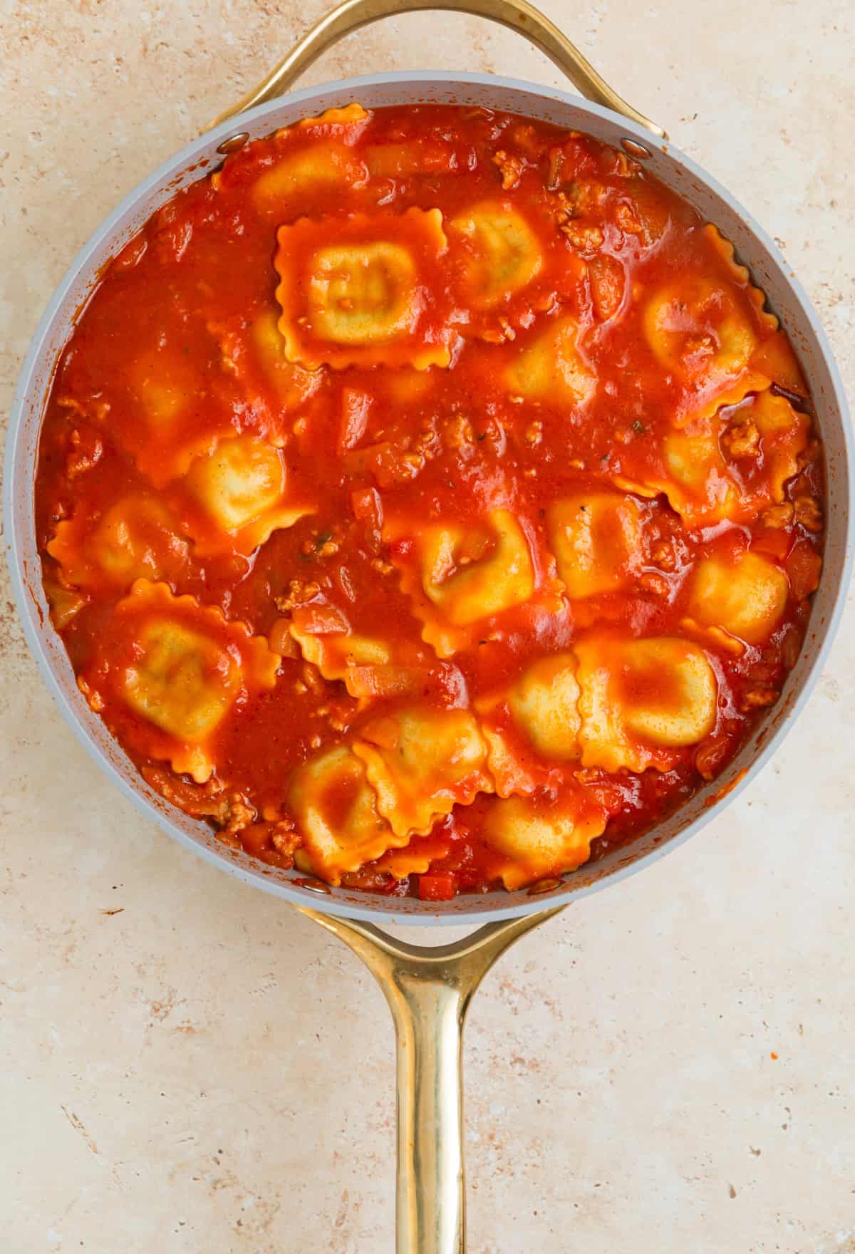 Lasagna cooked al dente in skillet with marinara.