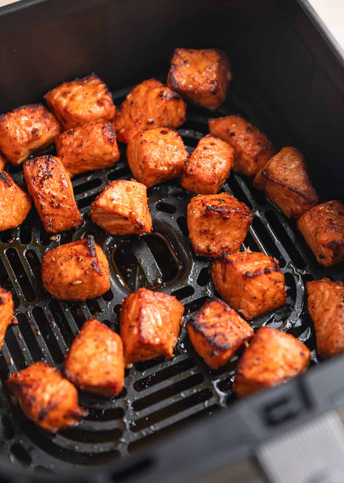 Air fried salmon bites in air frying basket.