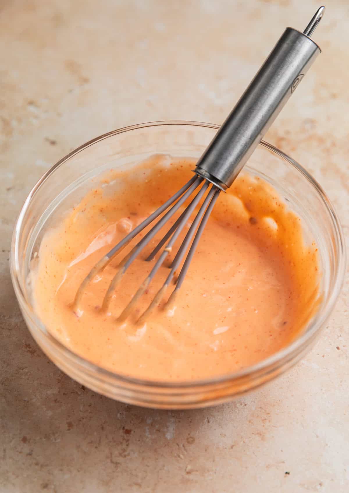 Whisk in stirred bang bang sauce in small glass dish.