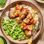 Air fryer salmon bites served with bang bang sauce over top and served on rice.