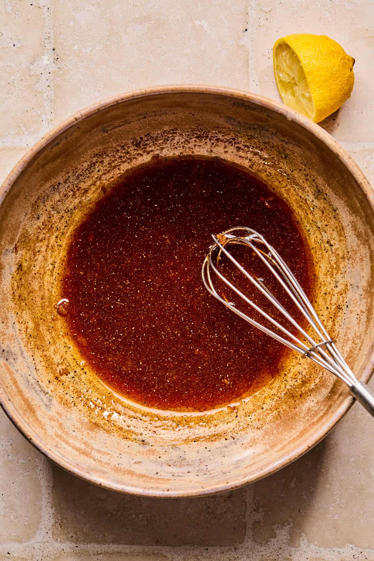 Salmon marinade in bowl with whisk.