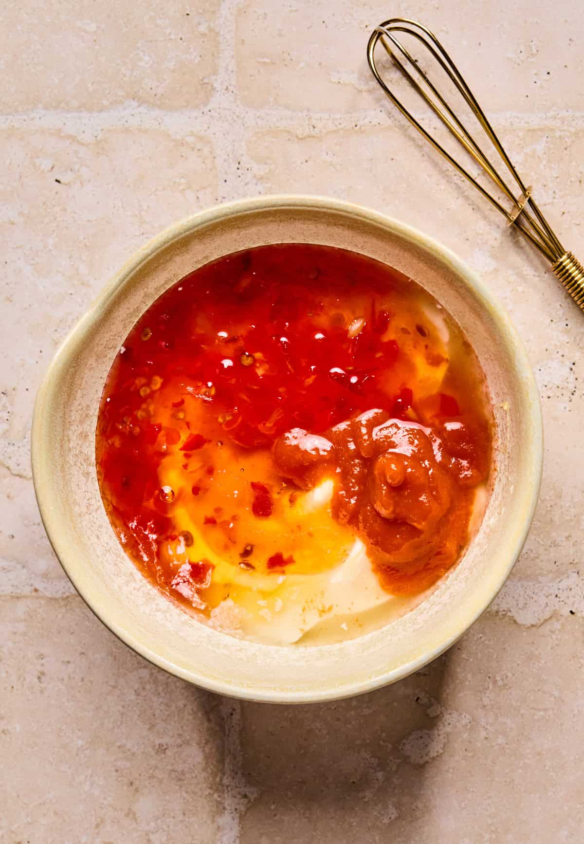 Mayo, sweet chili sauce, sriracha and honey in glass bowl.
