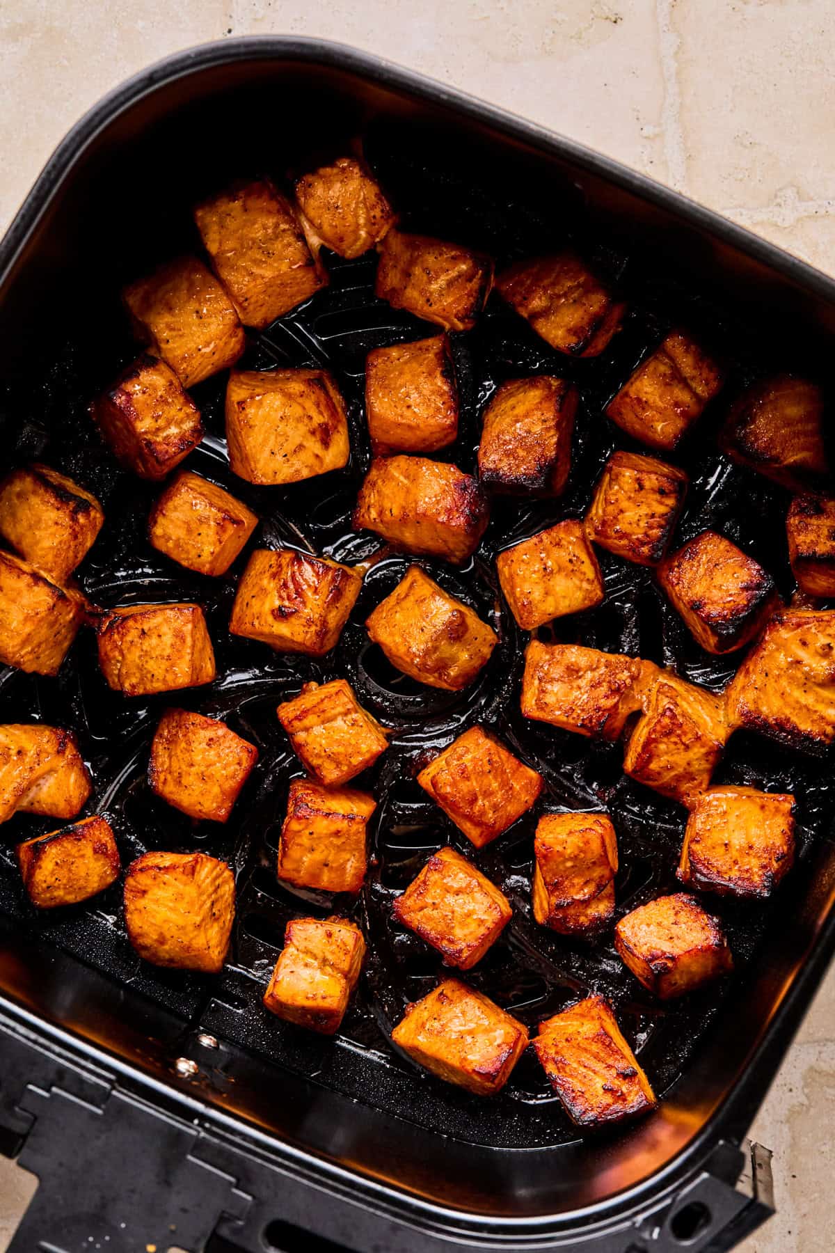 Air fried salmon bites in air frying basket.