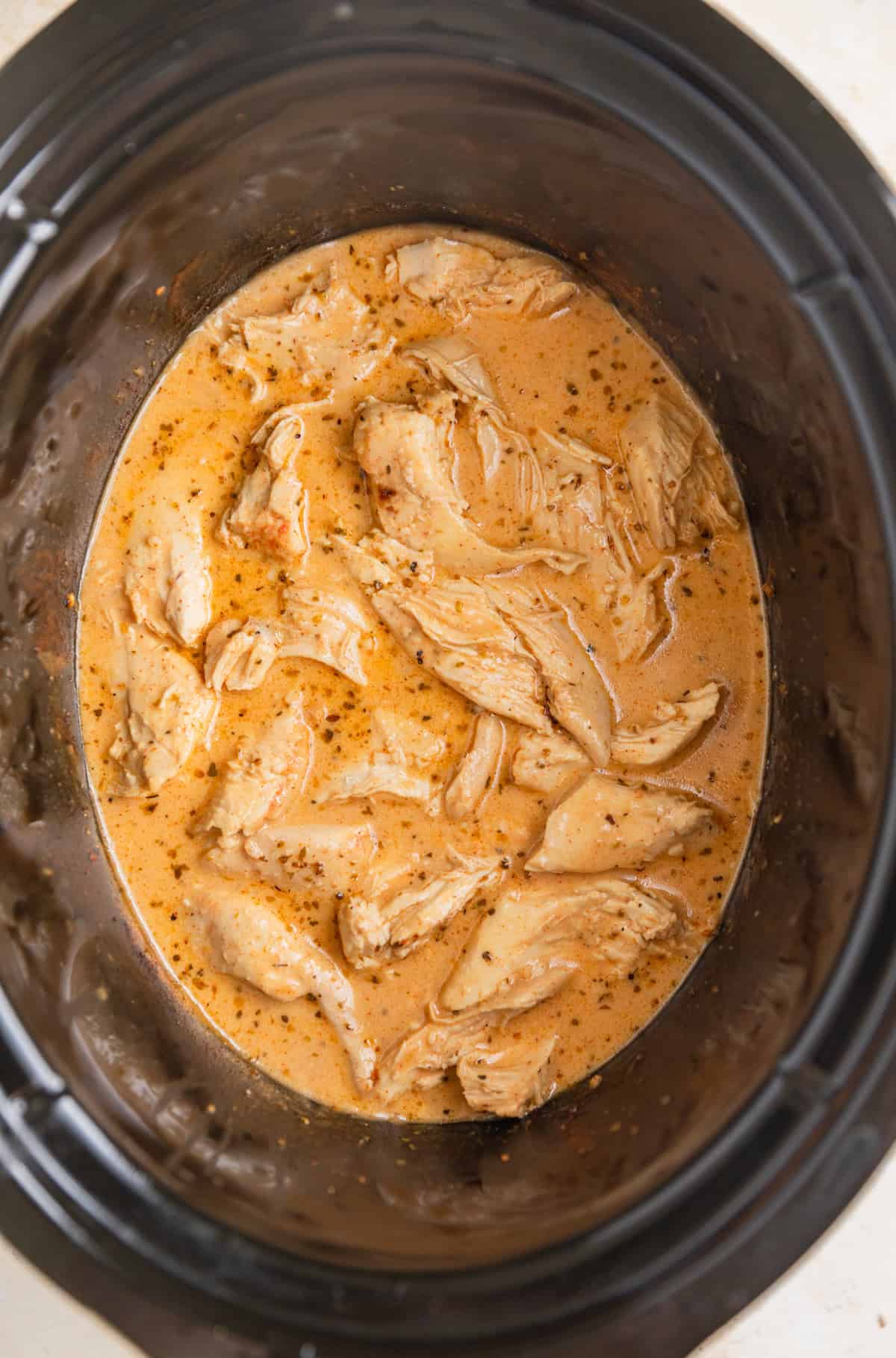 Cream added into honey mustard chicken in slow cooker.