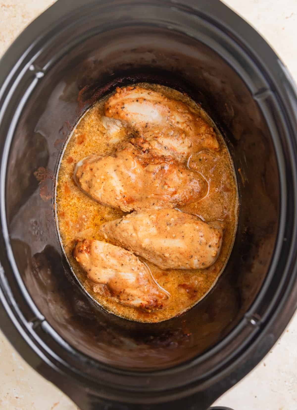 Cooked honey mustard chicken in pot.