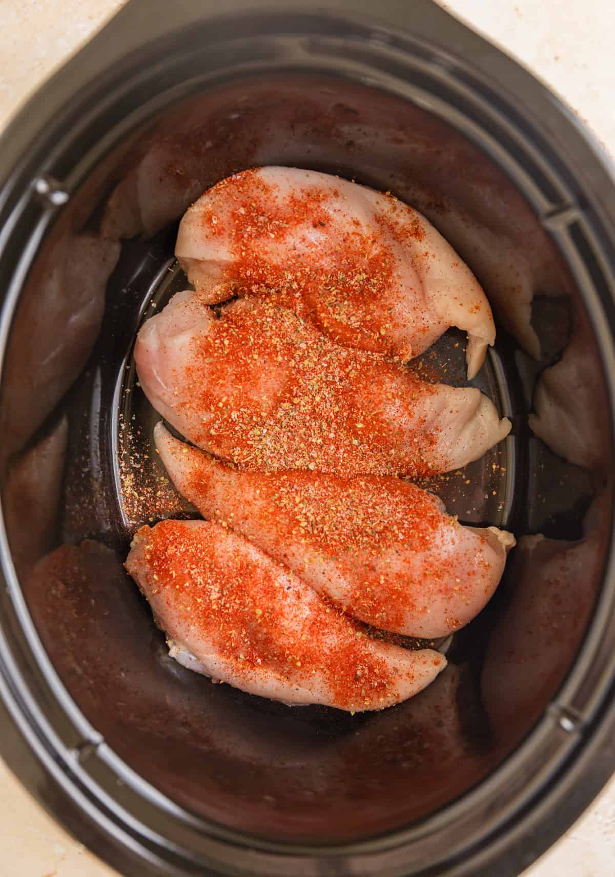 Seasoned chicken breasts in crock pot.