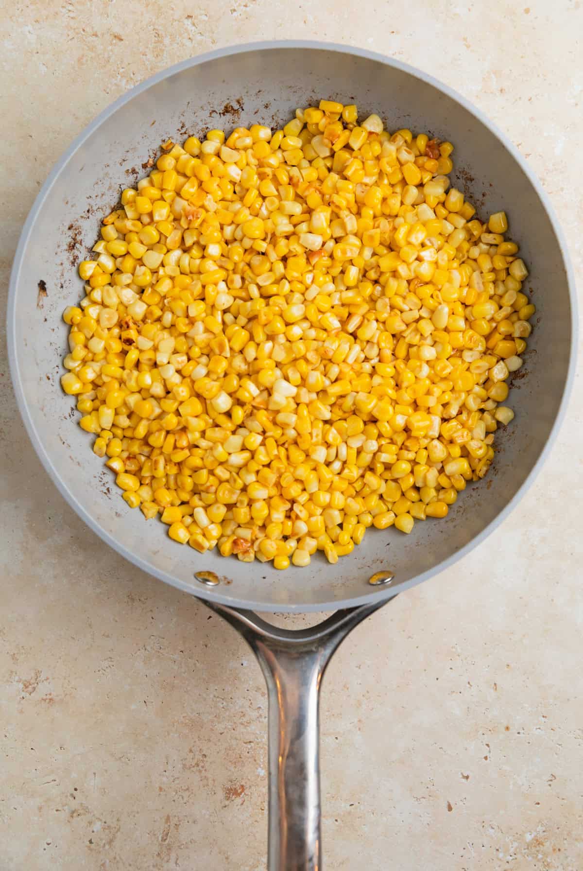 Corn kernels cooked in skillet.