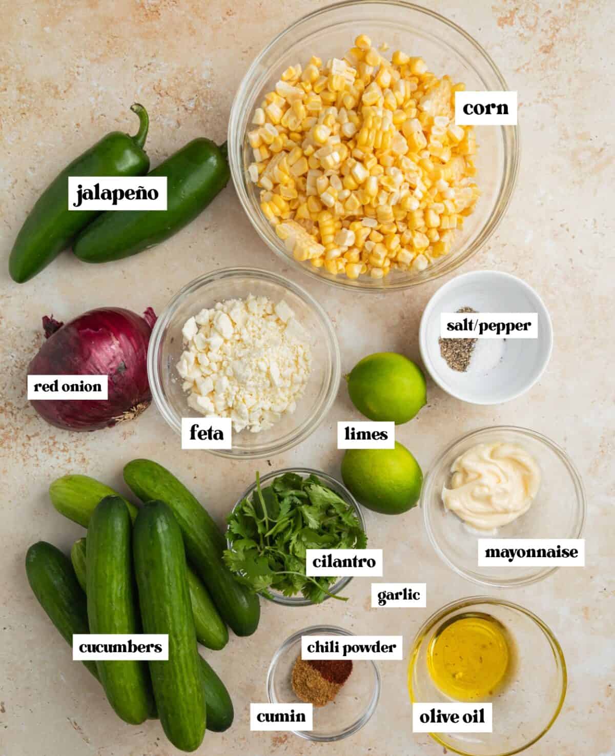 Bowl of corn, onion, olive oil, limes and other ingredients for recipe.