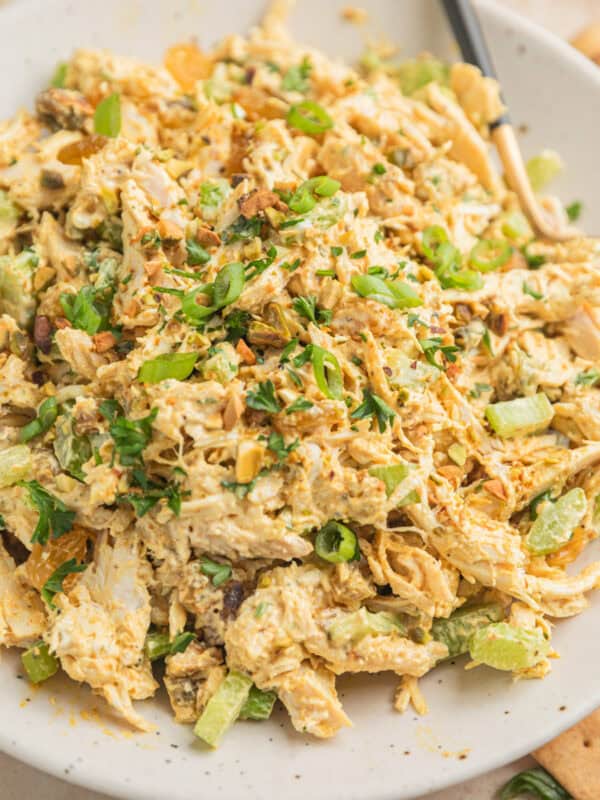 Curry chicken salad on plate with spoon.