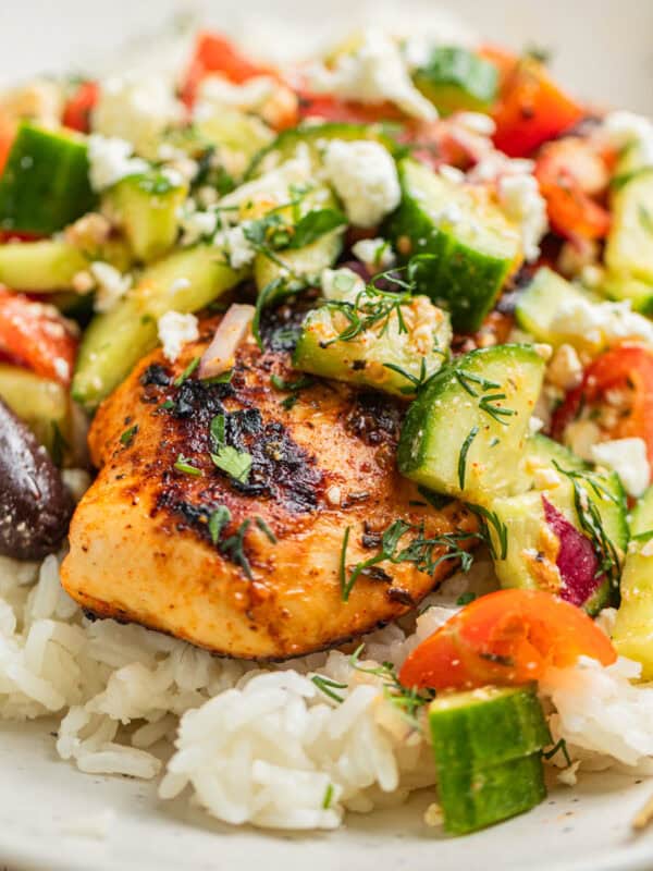 Mediterranean chicken served over rice and topped with cucumber salad.