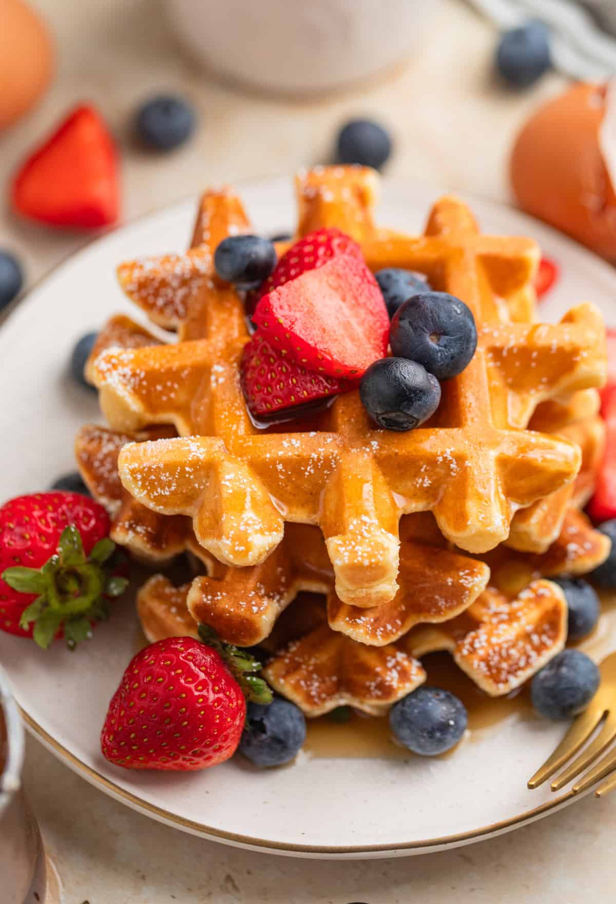 Cottage cheese waffles served on plate with berries.