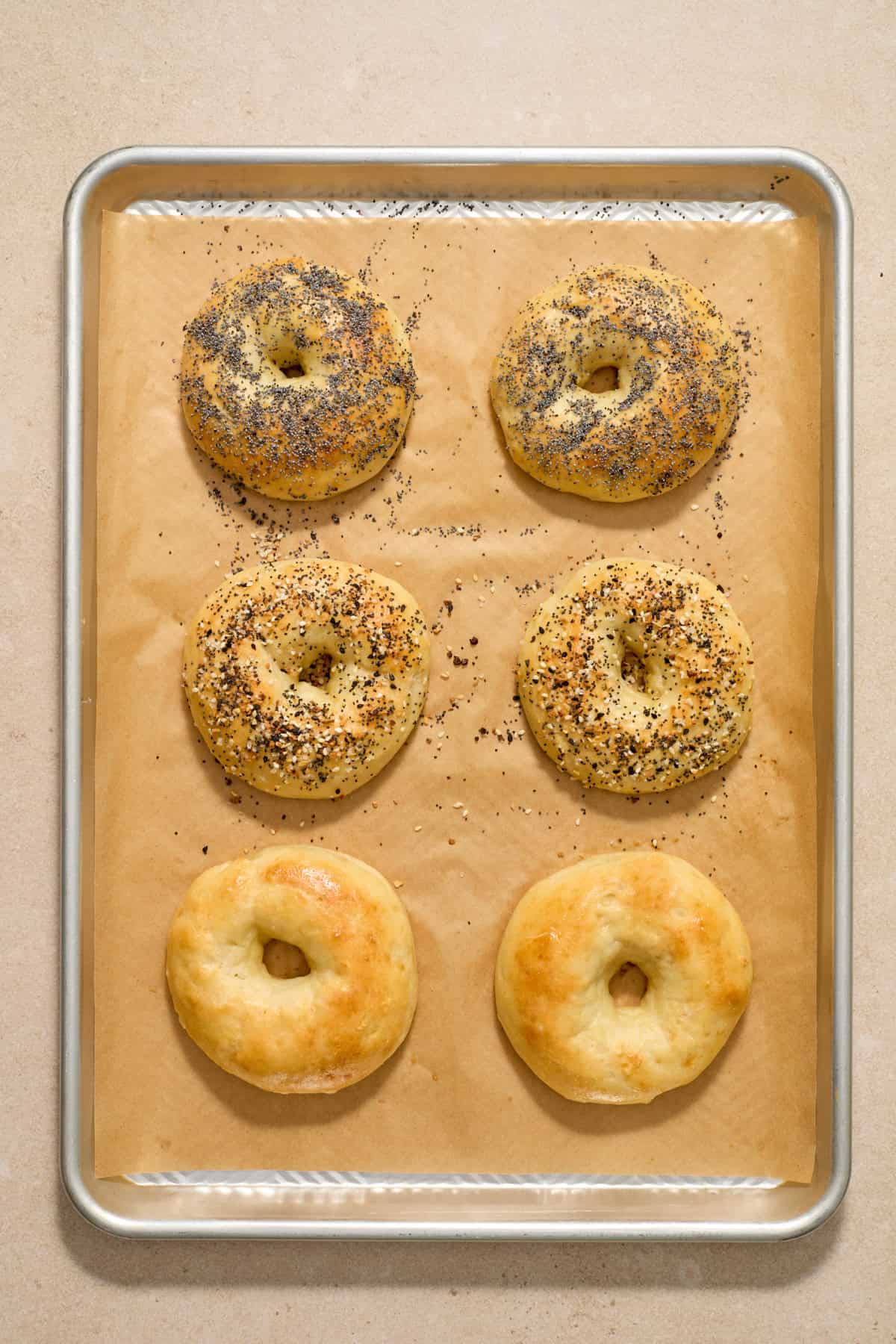 Baked protein bagels on parchment lined cookie sheet.