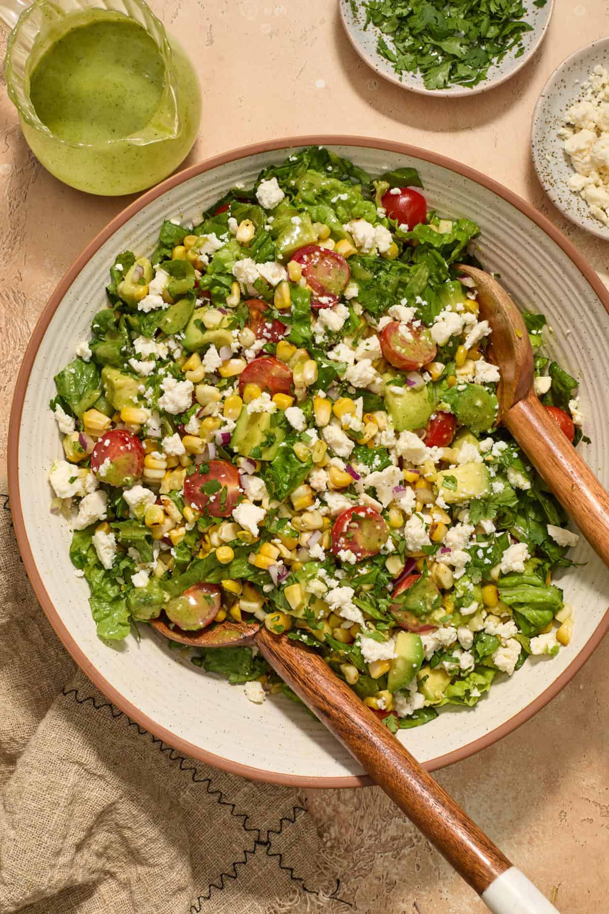 Tossed corn, tomato and avocado salad in bowl.