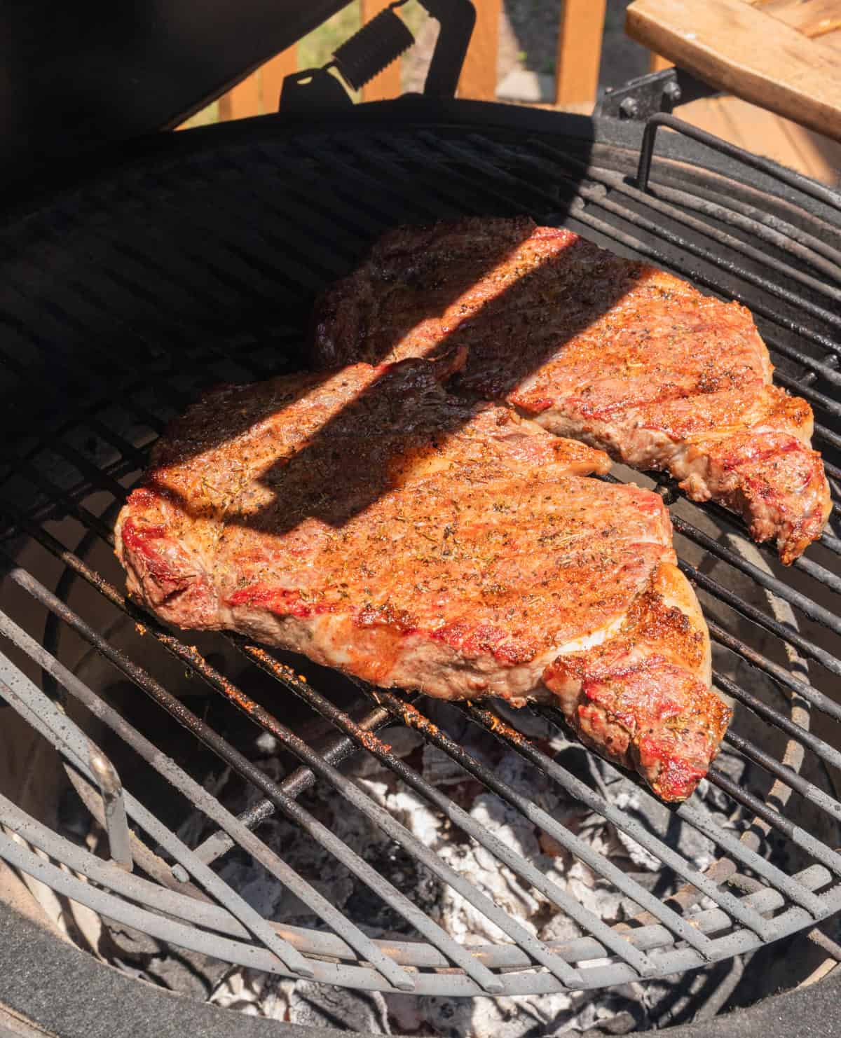 Ribeye steaks on grill.
