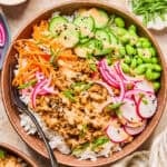 Rice bowl with ground turkey, bang bang sauce, cucumber, carrots and other ingredients.