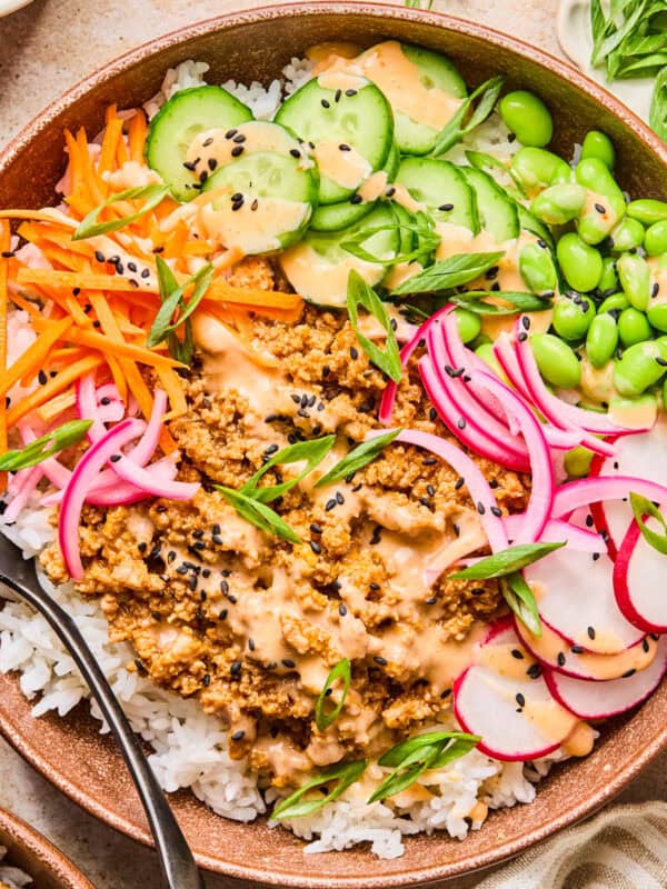 Rice bowl with ground turkey, bang bang sauce, cucumber, carrots and other ingredients.