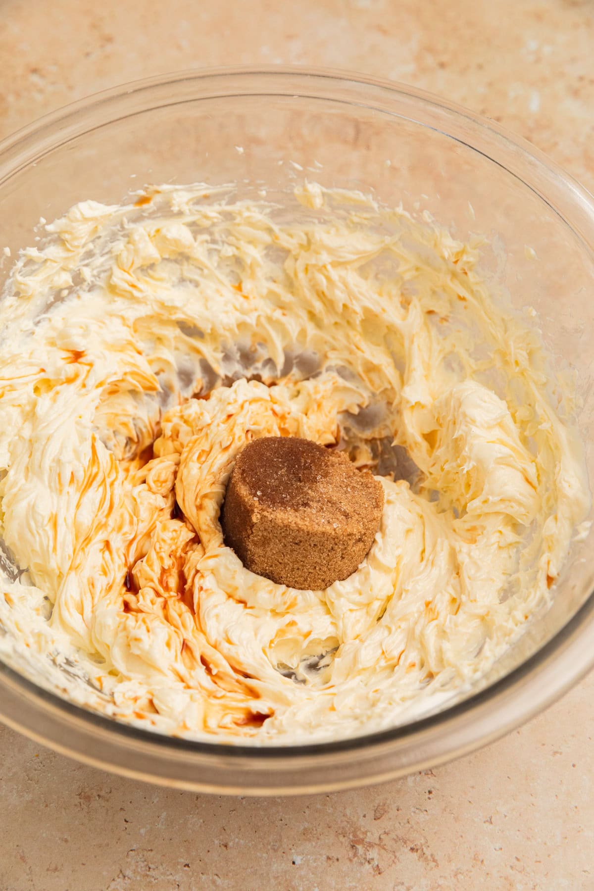 Cream cheese creamed in mixing bowl with brown sugar and vanilla added.