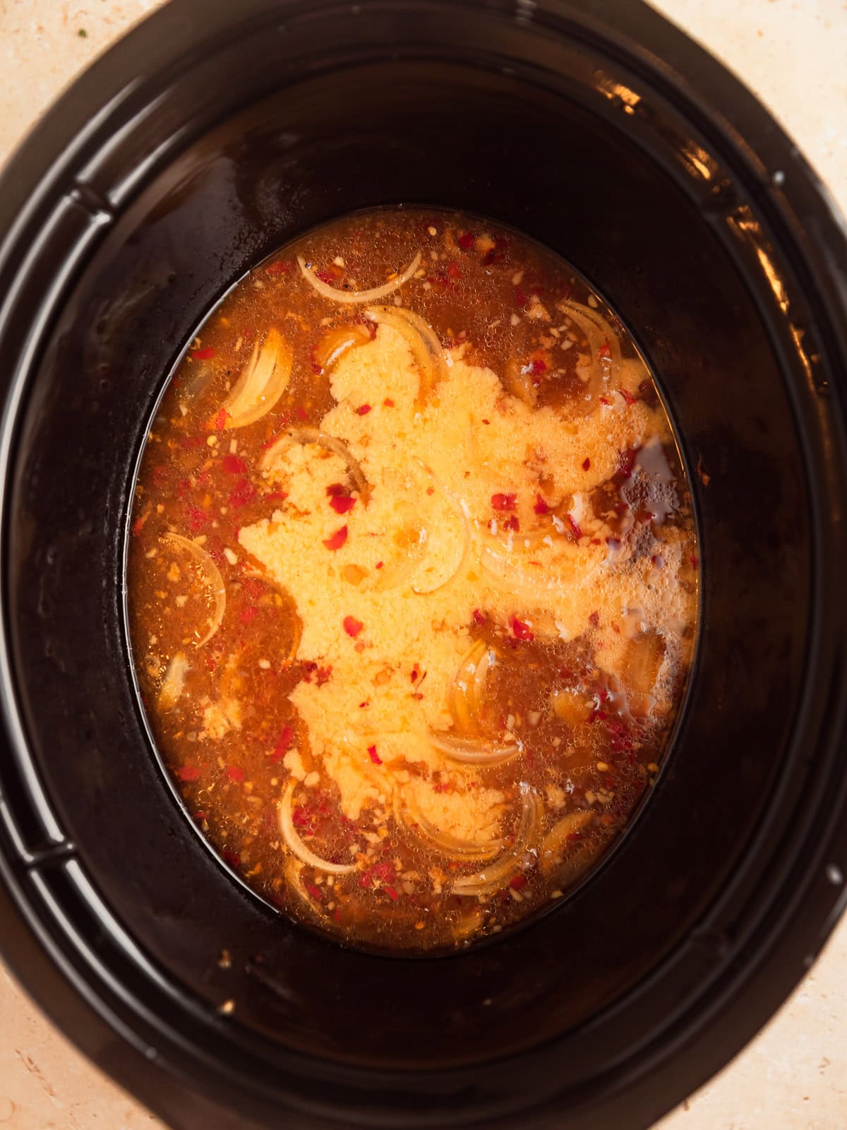 Slurry added to apricot mixture in crockpot.