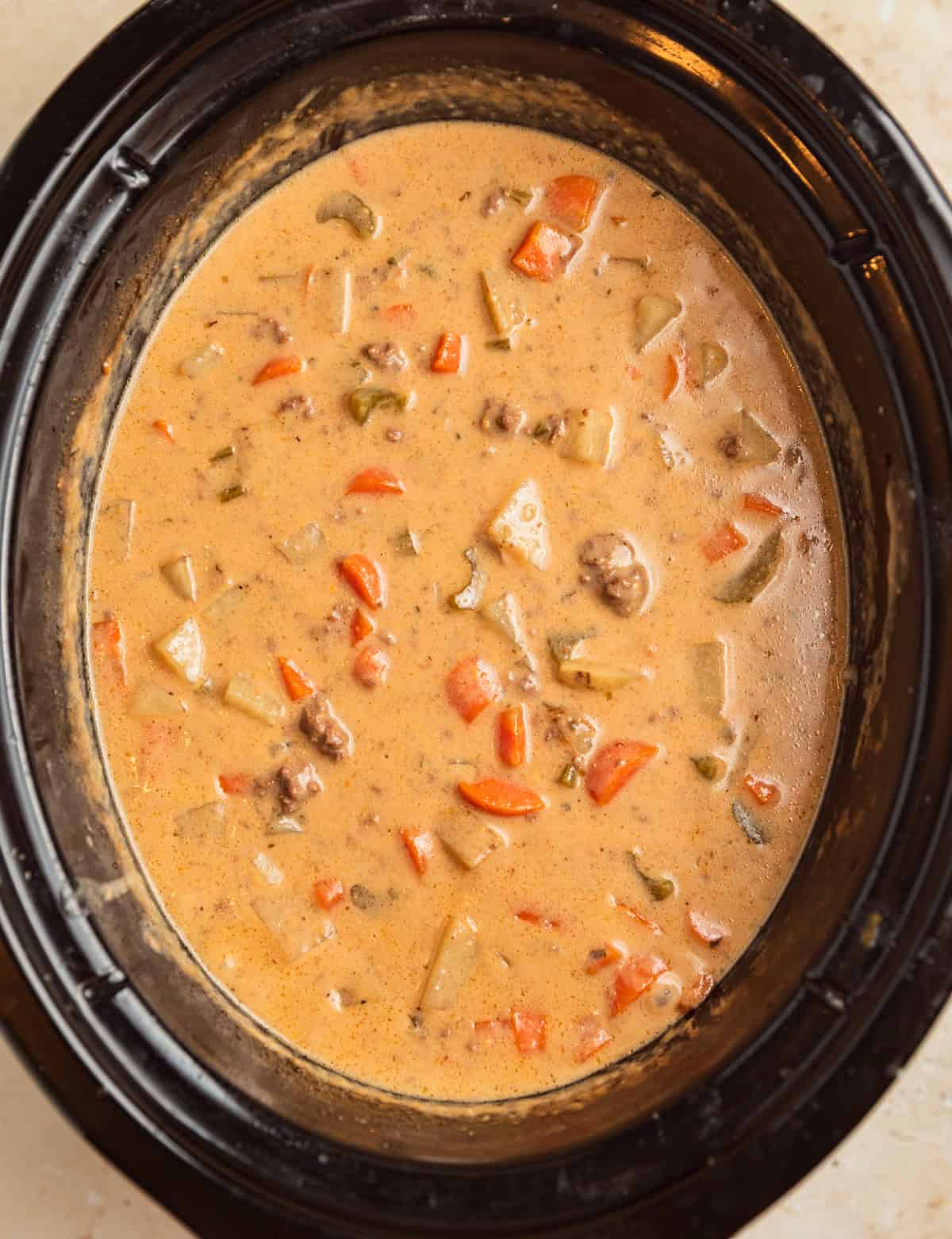 Crockpot cheeseburger soup in slow cooker after cheese is melted into the soup.