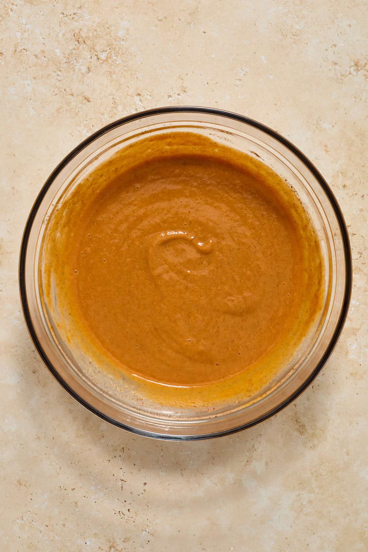 Pumpkin pie mixture in glass bowl.