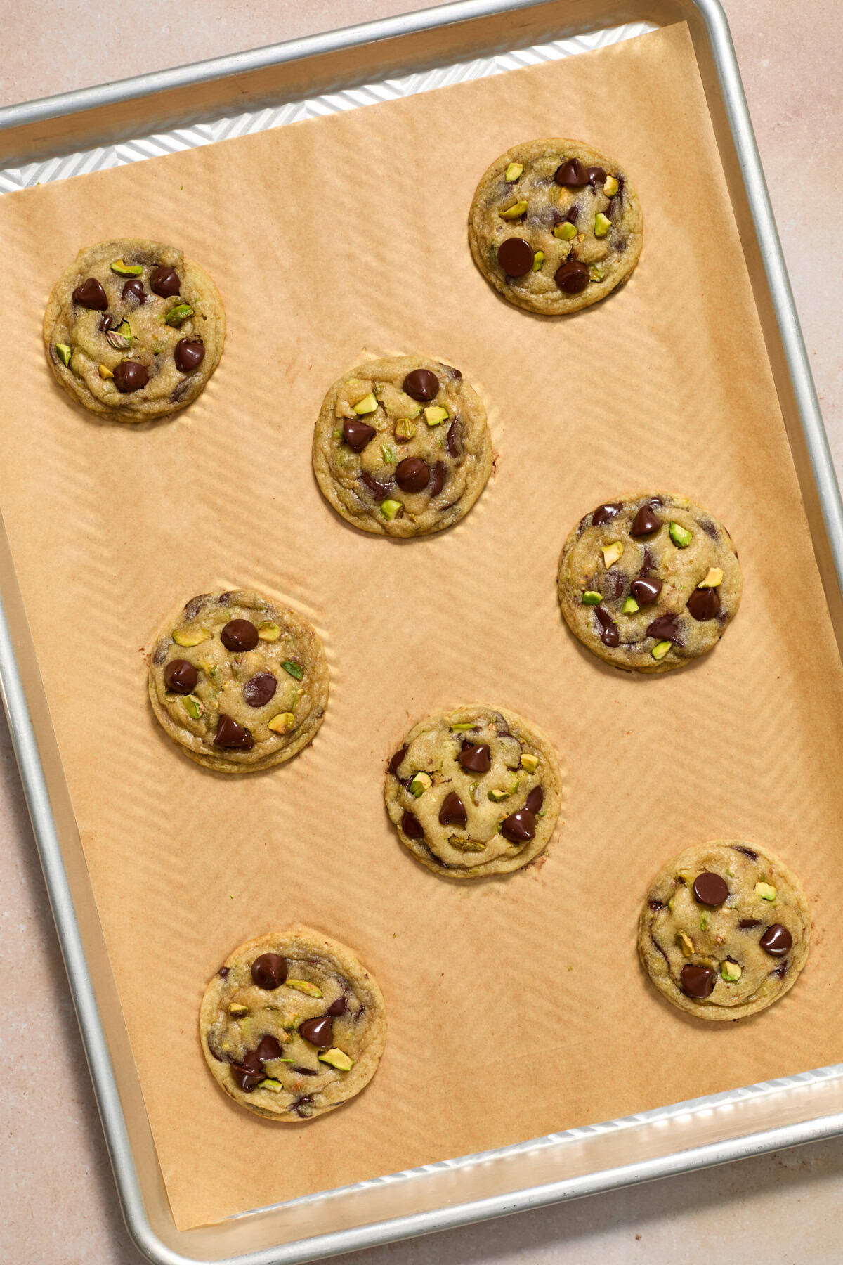 Freshly baked cookies on parchment lined baking sheet.