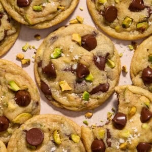 Pistachio chocolate chip cookies arranged on surface.