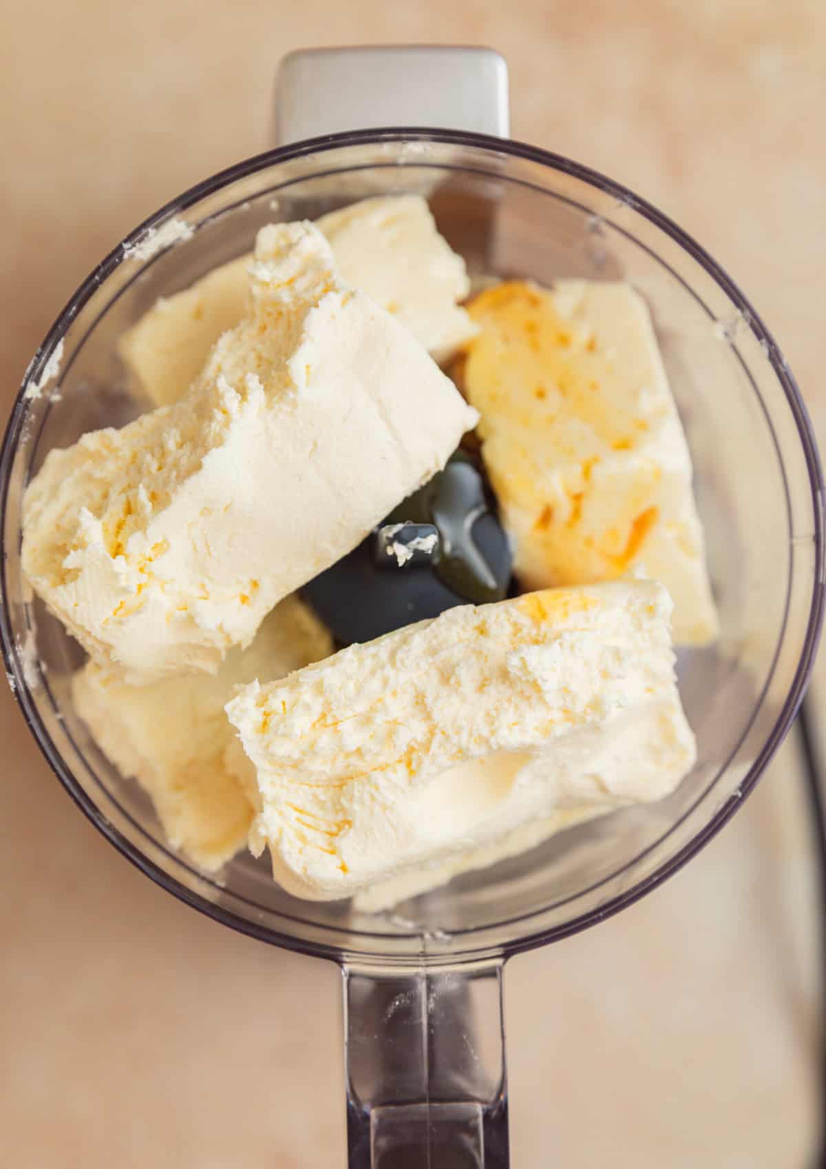 Cream cheese and block feta cheese with honey in food processor.