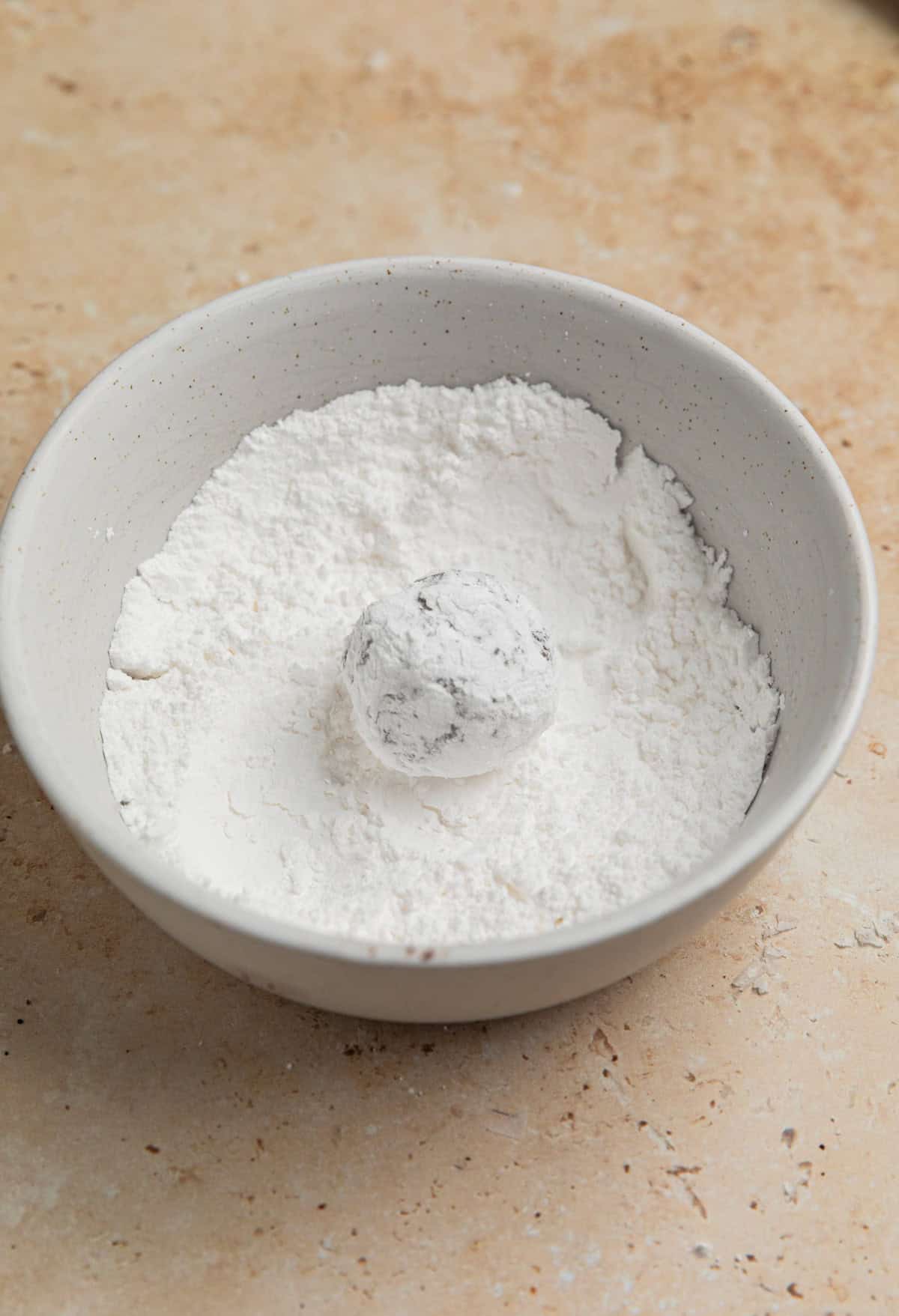 Cookie dough ball rolled into powdered sugar.