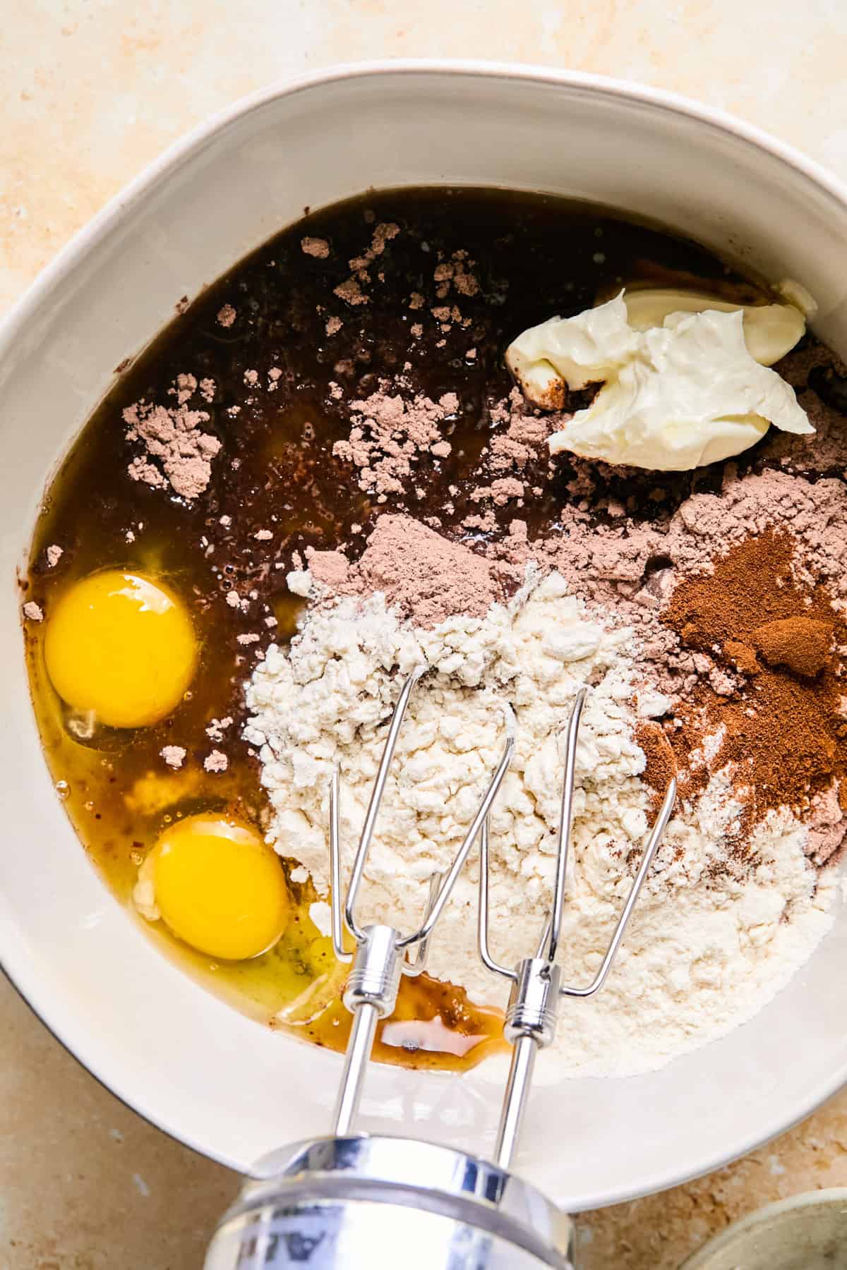 Mixing bowl with brownie mix, eggs, and other ingredients.