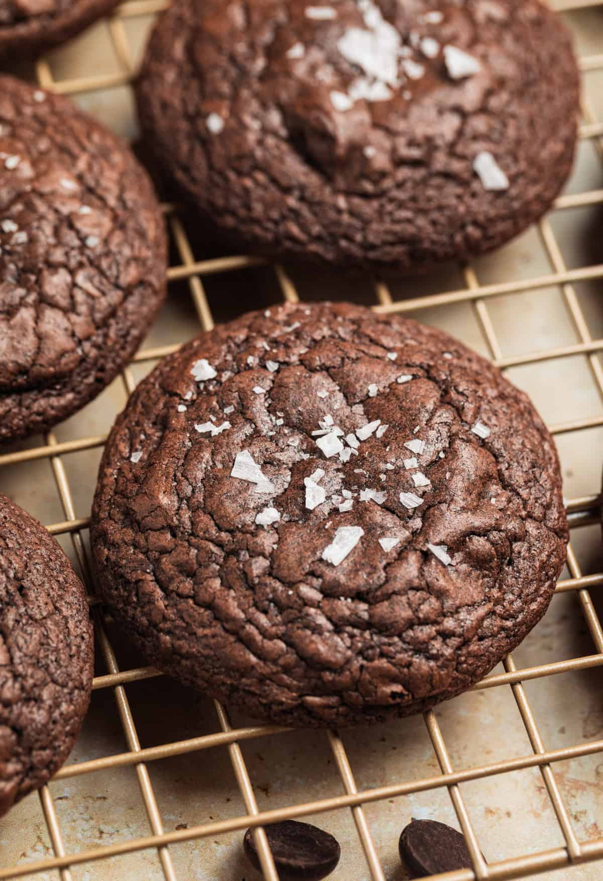 Brownie mix cookies on wire rack topped with flaked sea salt.