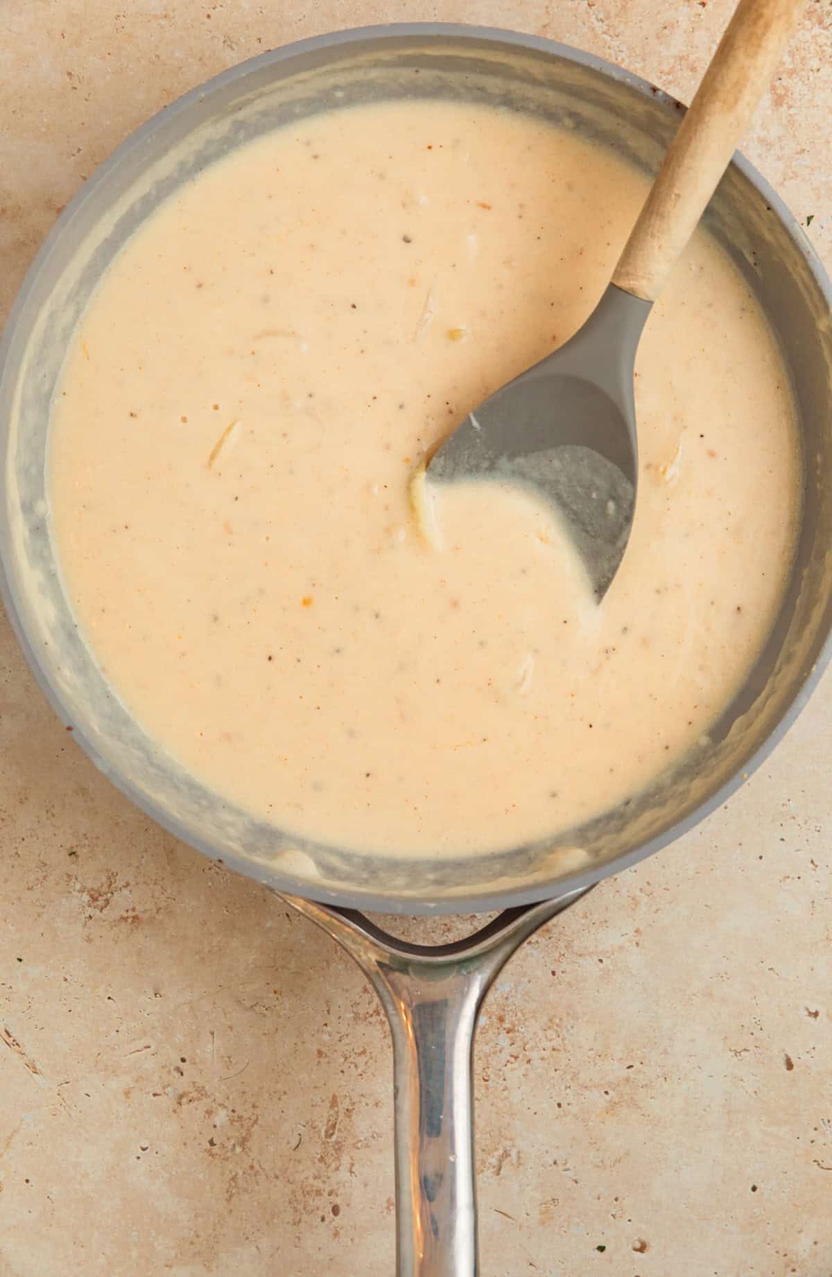 Gruyere cream sauce for scalloped potatoes in pan.