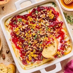 Honey whipped ricotta with cranberry sauce, thyme, pecans and honey over top.