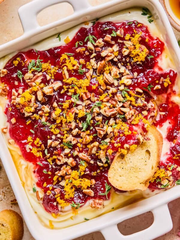Honey whipped ricotta with cranberry sauce, thyme, pecans and honey over top.