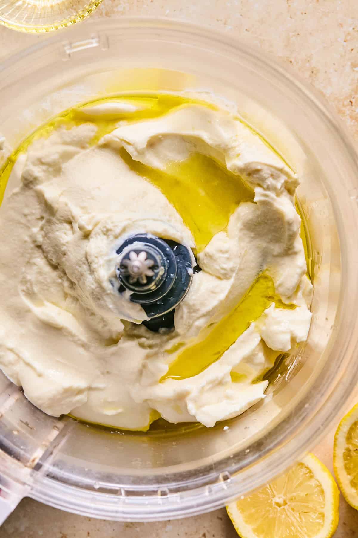 Ricotta, olive oil and sea salt in food processor before whipping.