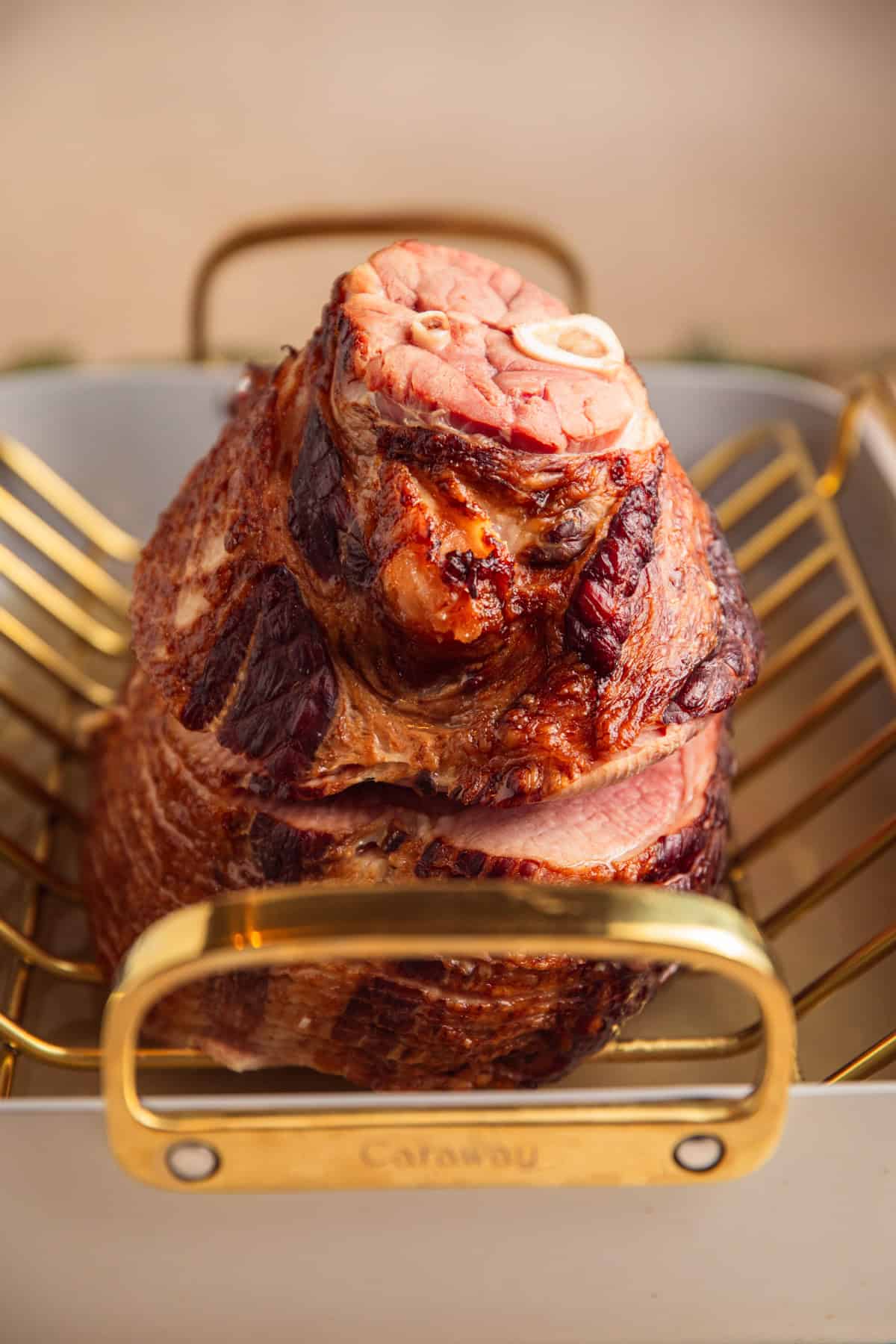 Roasted ham in pan with water.