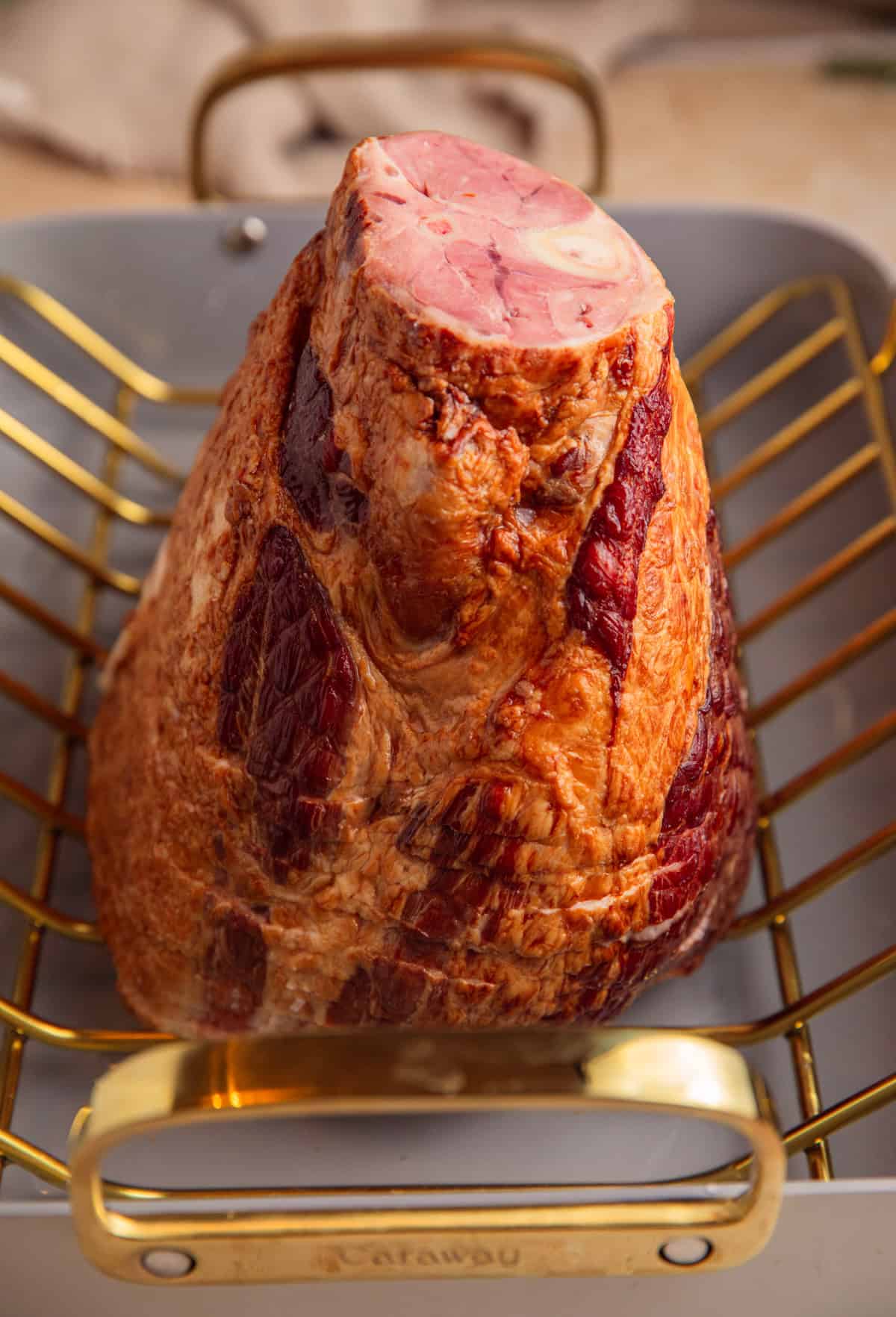 Spiral cut ham on roasting rack in roasting pan.