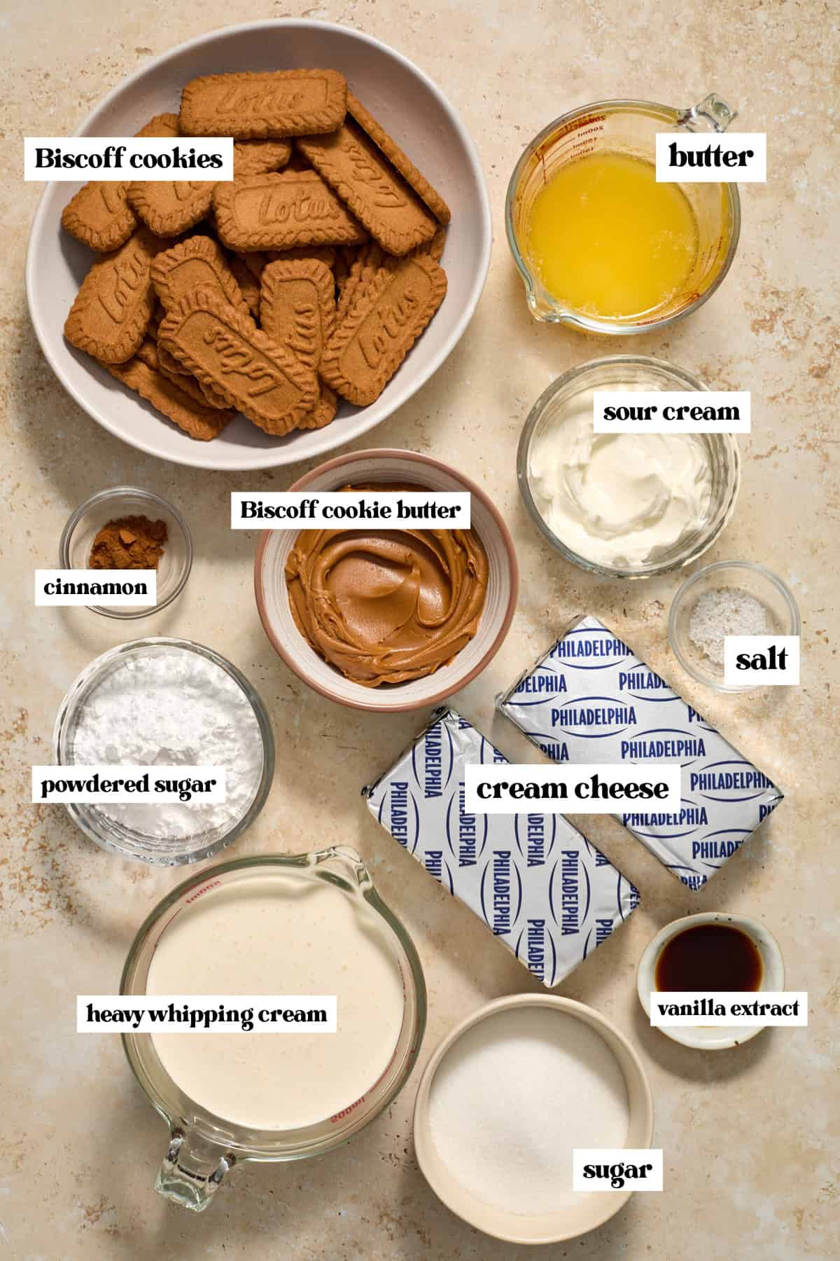 Lotus cookies, cream cheese, butter, and other ingredients arranged for recipe.